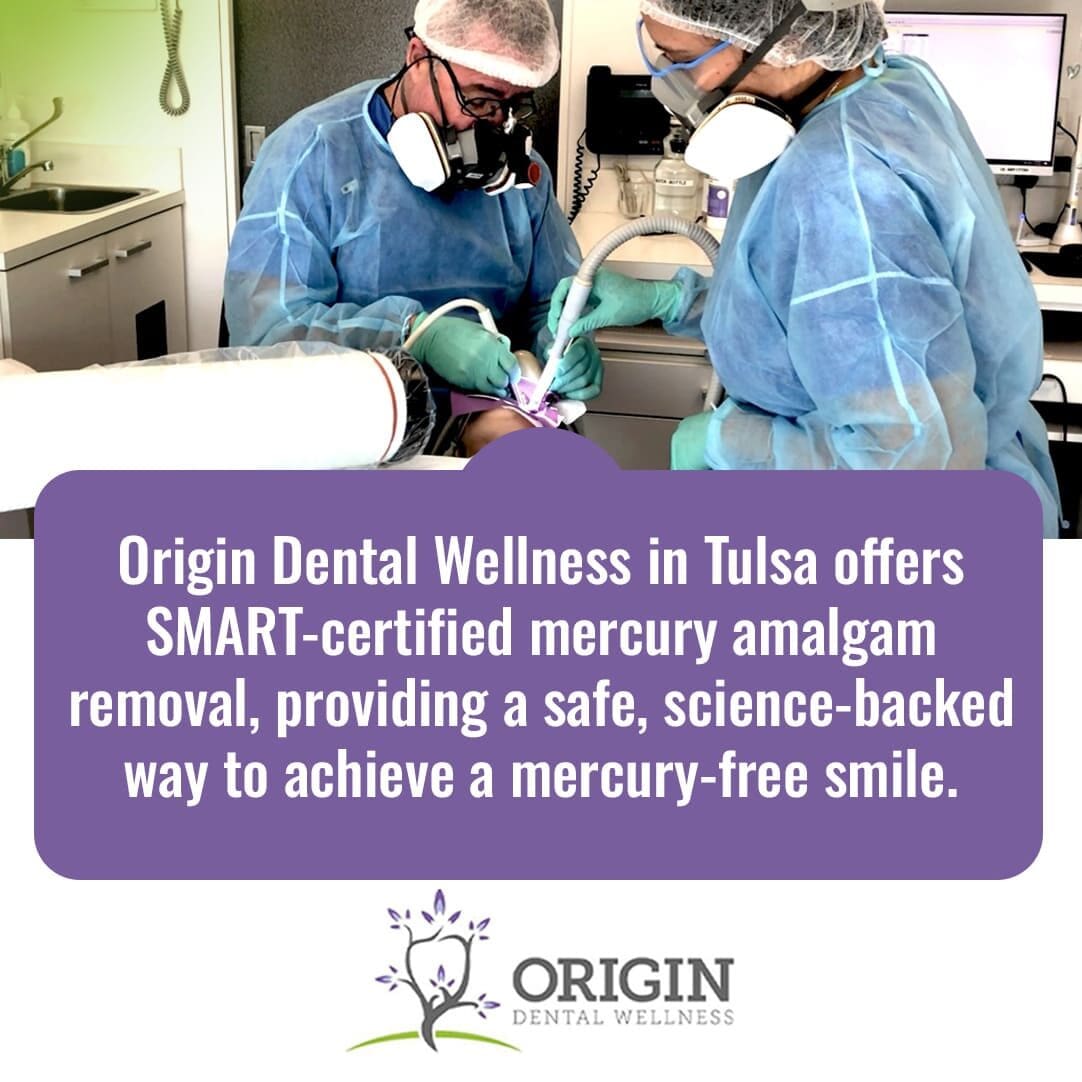 Two dental professionals wearing extensive protective gear (gowns, respirators) working on a patient.